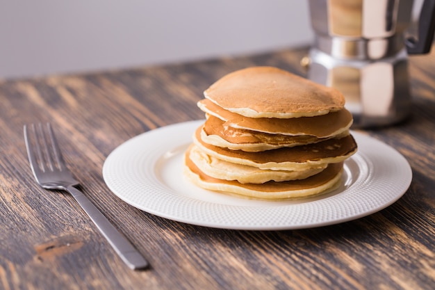 Pancakes with maple syrup on a plate