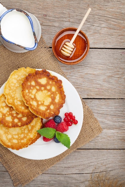 Pancakes with raspberry blueberry milk and honey syrup