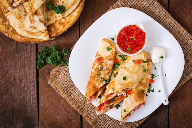 Pancakes with red caviar and cream cheese