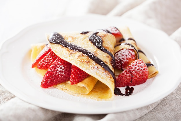 Pancakes with strawberry and chocolate sauce