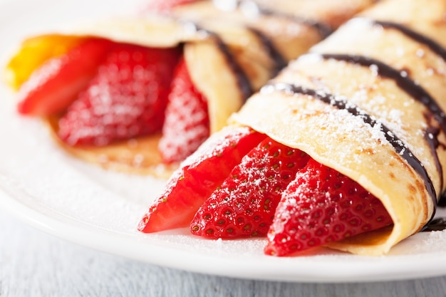 Pancakes with strawberry and chocolate sauce