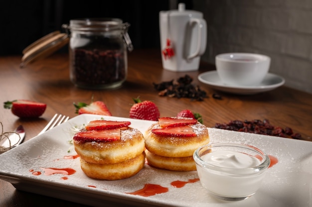 Pancakes with strawberry and jam on plate