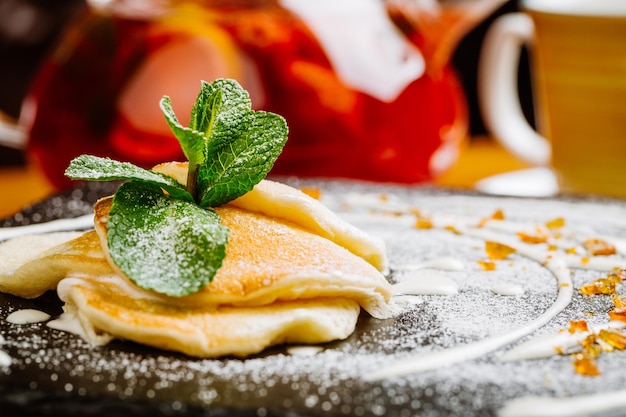 Pancakes with sweet sauce and jam traditional Russian meal on wooden backgrounddiet cooking culinary and food concept selective focus