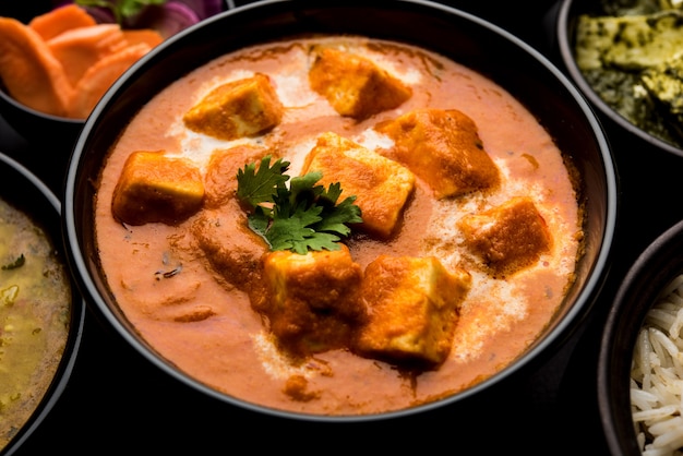 Paneer Butter Masala or Cheese Cottage Curry in serving a bowl or pan, served with or without roti and rice