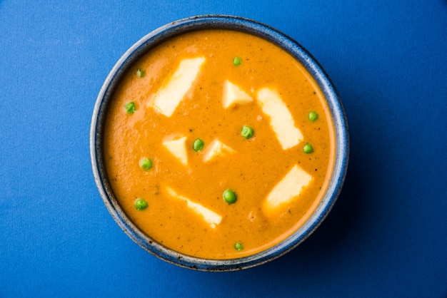 Paneer Butter Masala is famous indian food recipe made using cottage cheese, served in a bowl. selective focus