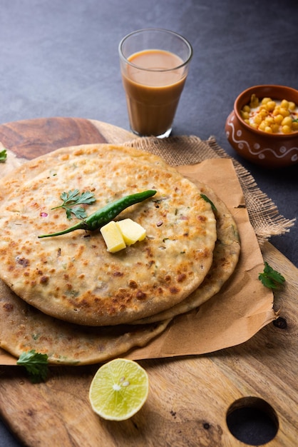 Paneer paratha is a popular North Indian flatbread made with whole wheat flour dough and stuffed with savory, spiced, grated paneer