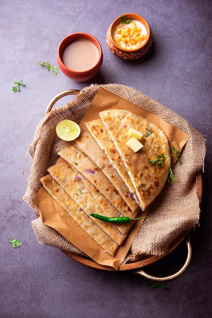 Paneer paratha is a popular North Indian flatbread made with whole wheat flour dough and stuffed with savory, spiced, grated paneer