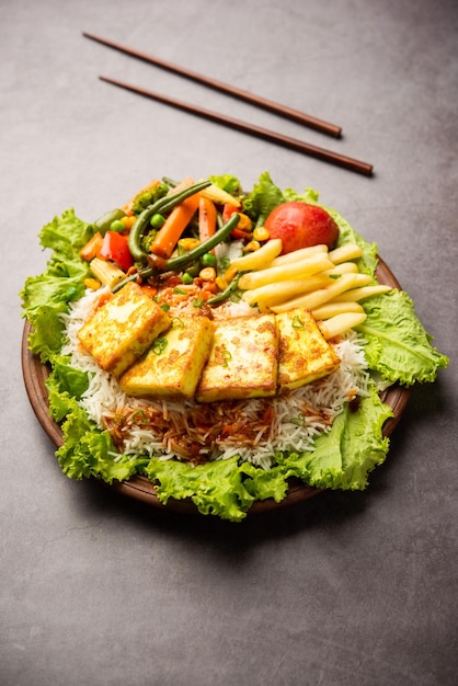 Paneer Sizzler is an Indian version with cottage cheese salad served sizzling on hot stone dish