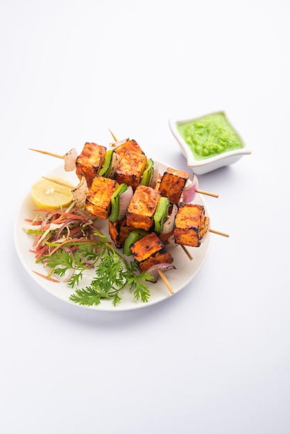 Paneer tikka is an Indian dish made from chunks of cottage cheese marinated in spices and grilled in a tandoor