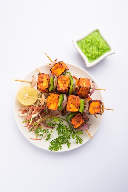 Paneer tikka is an Indian dish made from chunks of cottage cheese marinated in spices and grilled in a tandoor