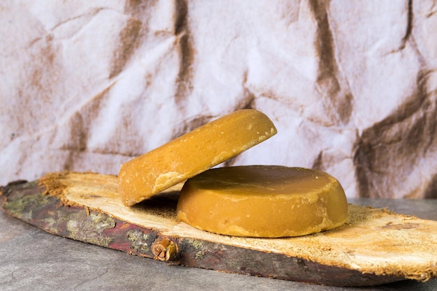 Panela or sweet sugar cane on a wooden trunk typical food of Colombia