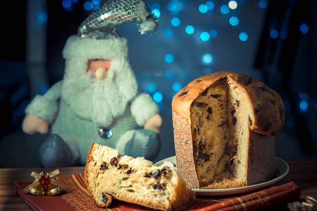 Panettone. Traditional italian dessert for christmas with chistimas light on background