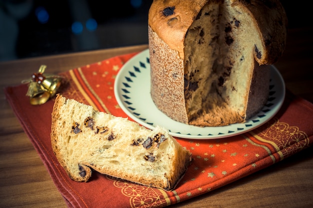 Panettone. Traditional italian dessert for christmas with chistimas light on background