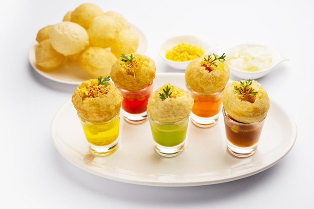 Panipuri shot or Golgappa Shots different flavours of water served in small glasses with stuffed puri Indian starter snack