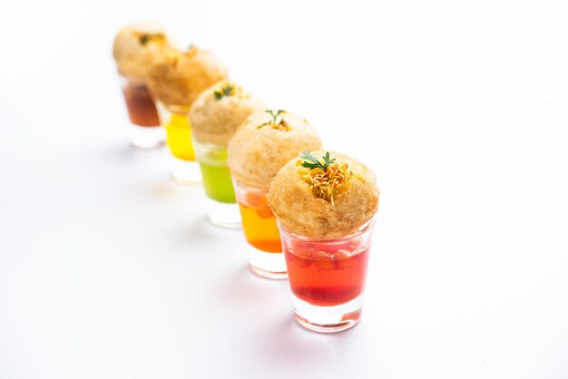 Panipuri shot or Golgappa Shots different flavours of water served in small glasses with stuffed puri Indian starter snack