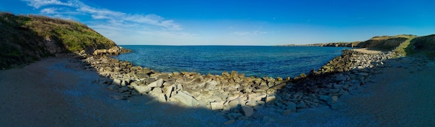 Panorama of a beach with sand and stones near the Black Sea under sunset light in Bulgaria