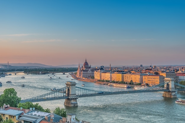 Panorama of Budapest at sunset. Hungarian landmarks: Chain Bridge, Parliament and Danube river in Budapest.