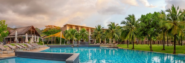 Panorama of the chic five star hotel with pool the sands of katathani. Evening order, palm trees and green grass. vacation spot