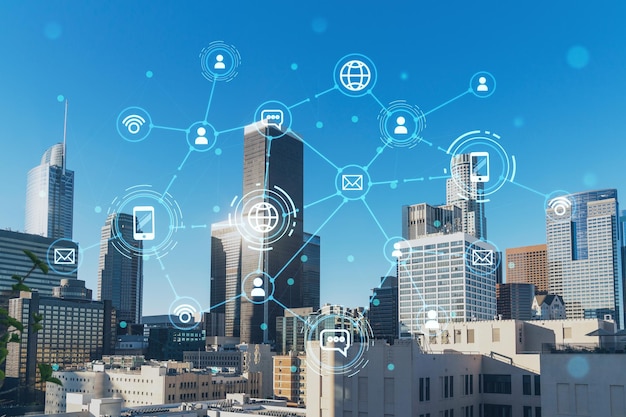 Panorama cityscape of Los Angeles downtown at day time California USA Skyscrapers of LA city Glowing Social media icons The concept of networking and establishing new connections between people