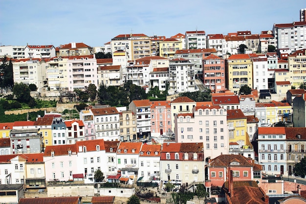 Panorama of Coimbra town former medieval capital of Portugal View of colorful houses and roof tops over blue sky European travel concept