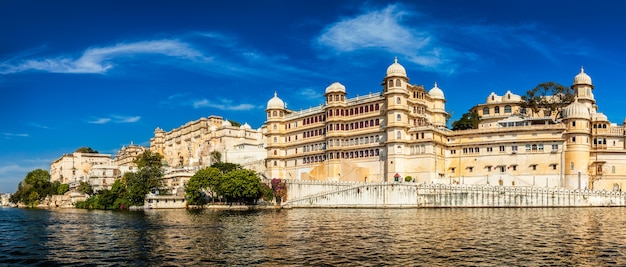 Panorama of famous romantic luxury Rajasthan indian tourist landmark - Udaipur City Palace on sunset with cloudy sky - surface level view. Udaipur, Rajasthan, India