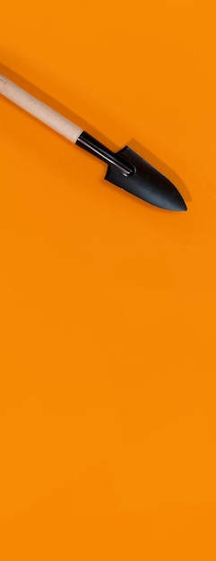 Panorama of garden tools on orange background