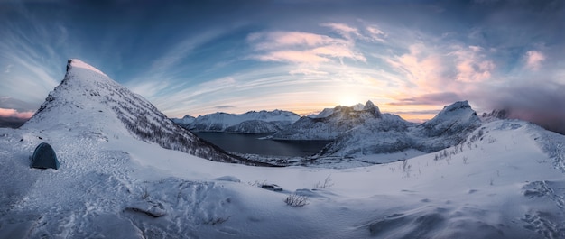 Panorama of Hiking on snowy mountain range in sunrise on Segla peak at Senja Island, Norway