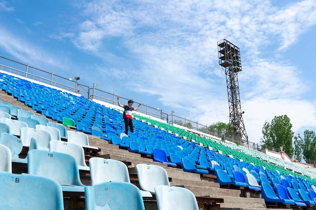 Panorama of huge stadium seats with a man watching the music event concerts