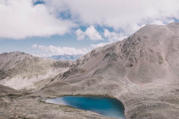 Panorama of lake scenes in mountains, national park Dombay, Caucasus, Russia, Europe. Dramatic blue sky and sunny landscape in summer day