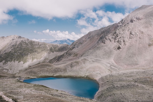 Panorama of lake scenes in mountains, national park Dombay, Caucasus, Russia, Europe. Dramatic blue sky and sunny landscape in summer day