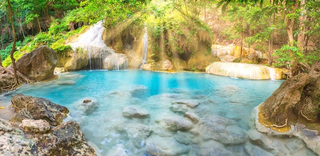 Panorama landscape of lake with cascades of waterfall in tropical forest in Erawan Thailand