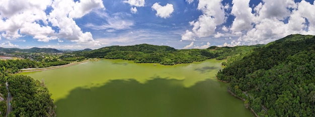 Panorama landscape nature lake or pond Aerial view drone shot of scenery mountain green tropical rainforest and blue sky in phuket thailand