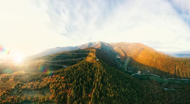 Panorama of the mountain and the mountain road in the autumn time while the sun is setting.