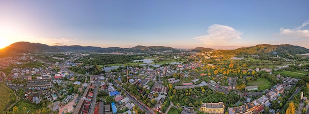 Panorama nature view Aerial view of Kathu district Phuket Thailand from Drone camera High angle viewBeautiful building in sunset or sunrise sky landscape Mountains view