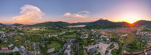 Panorama nature view Aerial view of Kathu district Phuket Thailand from Drone camera High angle viewBeautiful building in sunset or sunrise sky landscape Mountains view