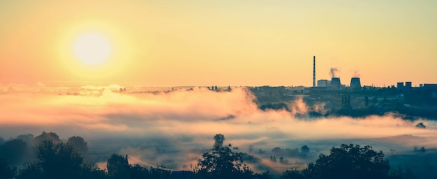 Panorama power station and the dawn with mist