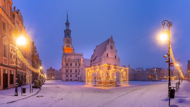 Panorama of Poznan Town Hall and Christmas tree at Old Market Square in Old Town in the snowy night, Poznan