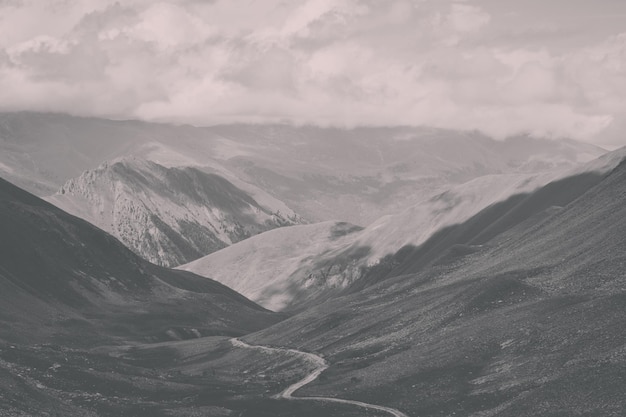 Panorama of road in mountains of national park Dombay, Caucasus, Russia, Europe. Summer landscape, sunshine weather, dramatic blue sky and sunny day