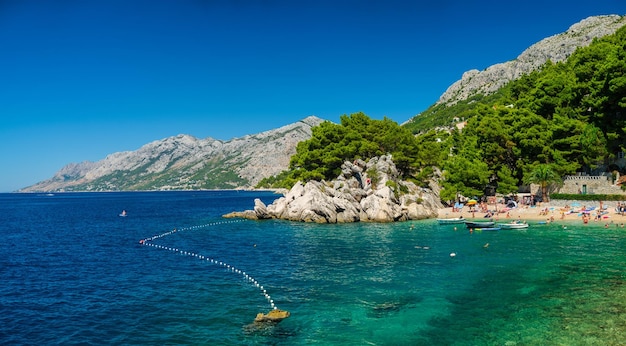 Panorama of the sea coast of Croatia Brela Makarska Riviera Beach and Adriatic Sea Summer season for vacation and recreation Seascape in the daytime