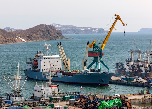 Panorama on ships at pier, port cranes on commercial seaport Petropavlovsk-Kamchatsky