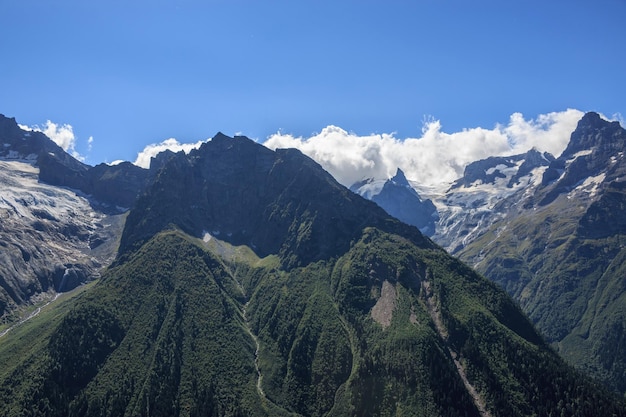 Panorama view of dramatic blue sky and mountains scene in national park Dombay, Caucasus, Russia. Summer landscape and sunny day