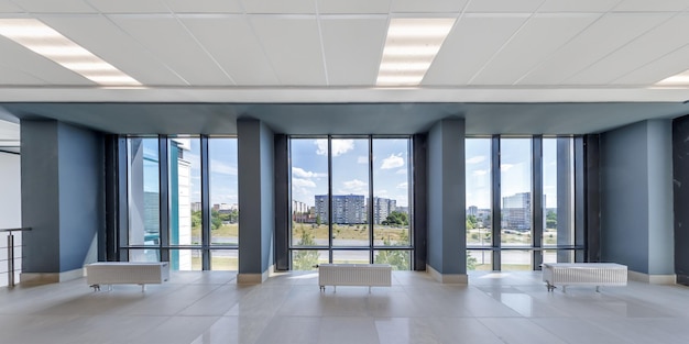 panorama view in empty modern hall with columns doors and panoramic windows