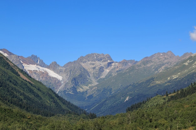 Panorama view of mountains scenes in national park Dombay, Caucasus, Russia, Europe. Summer landscape day and sunny blue sky