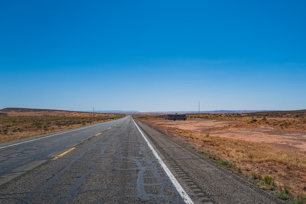 Panorama view of road running through the barren scenery of the american southwest