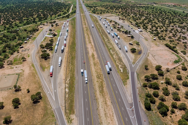 Panoramic aerial horizontal view of rest area truck stop on the car parking endless interstate highw...