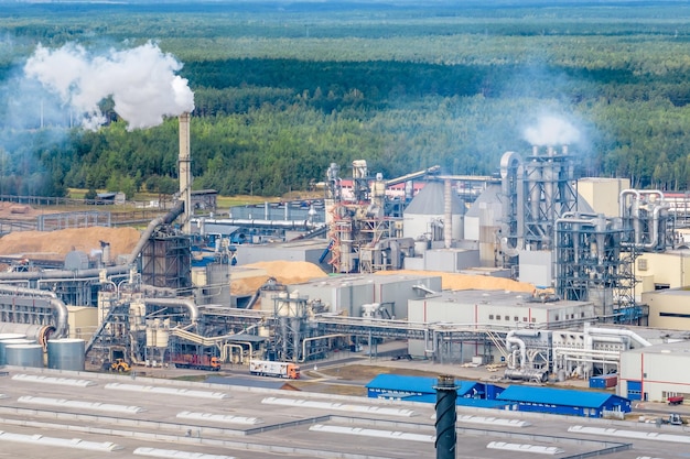 Panoramic aerial view of the smoke of pipes as background of huge residential complex with highrise buildings and private sector Air and water pollution concept