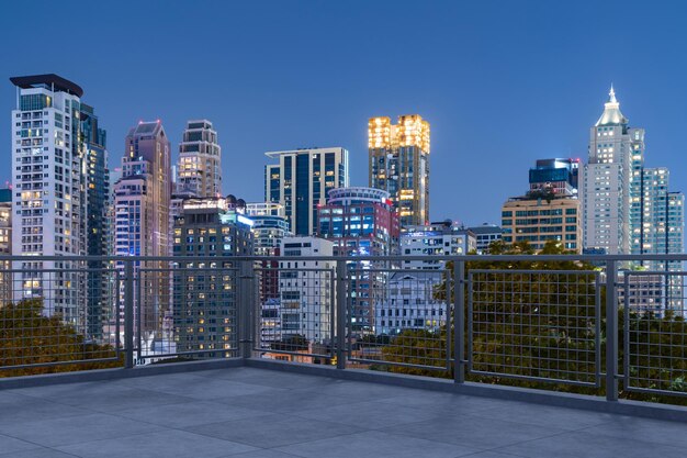 Panoramic Bangkok skyline view concrete observatory deck on rooftop night time Asian corporate and residential lifestyle Financial city downtown real estate Product display mockup empty roof