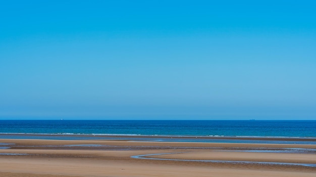 Panoramic beach landscape with clear skies in relaxing summer atmosphere