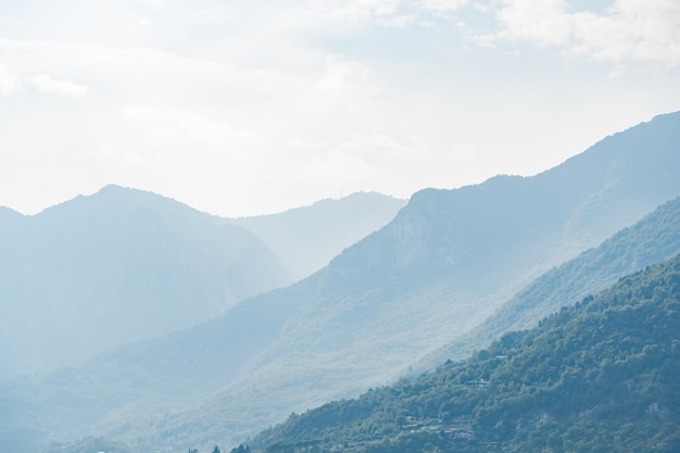 Panoramic blurred foggy mountain landscape near como lake in italy