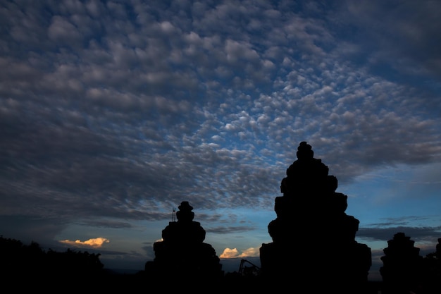 Panoramic cloudscape with the sun rays radiating from behind the cloudPhnom Bakheng sunset view Angkor Wat Siem Reap Cambodia